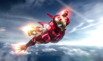 Iron Man soaring through a bright sky in iconic red and gold armor | 4K Wallpaper for Desktop