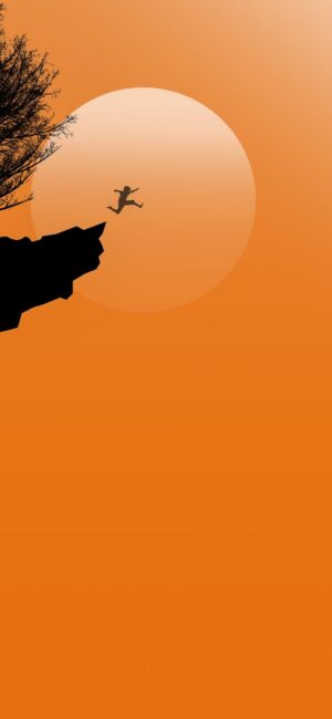 Silhouette of person jumping off cliff against setting sun & vibrant orange sky, framed by branches | 8K Wallpaper for Mobile