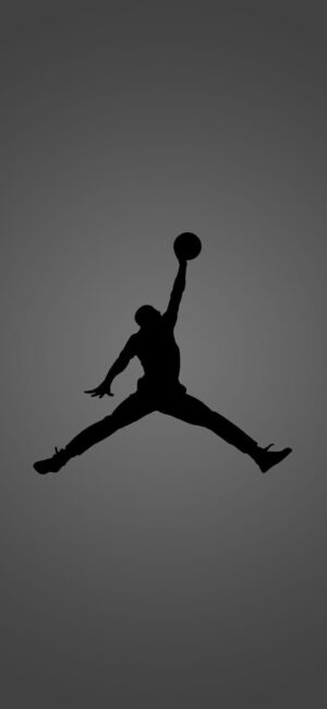 Silhouette of a basketball player in mid-air jump shot on a gray gradient background | 4K Wallpaper for Mobile