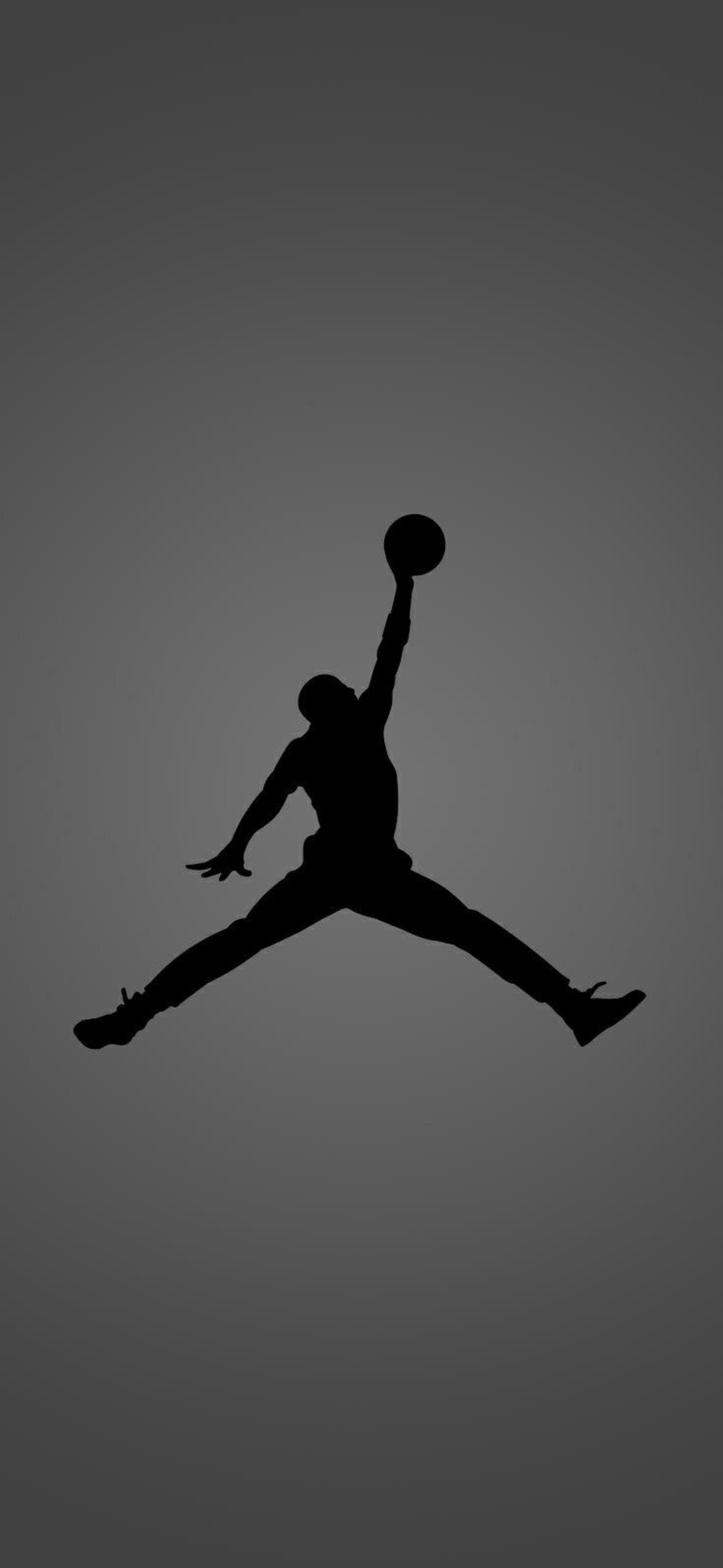 Silhouette of a basketball player in mid-air jump shot on a gray gradient background | 4K Wallpaper for Mobile