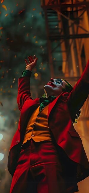 Clown character in red suit, green shirt, yellow vest with falling leaves on dark background | 4K Wallpaper for Mobile