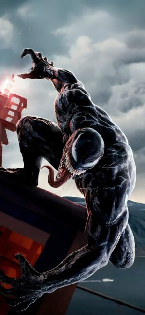 Venom in a fierce pose on a structure against a cloudy sky | Black, Gray, Red | Marvel, Superhero Comic Art | 4K Wallpaper for Mobile