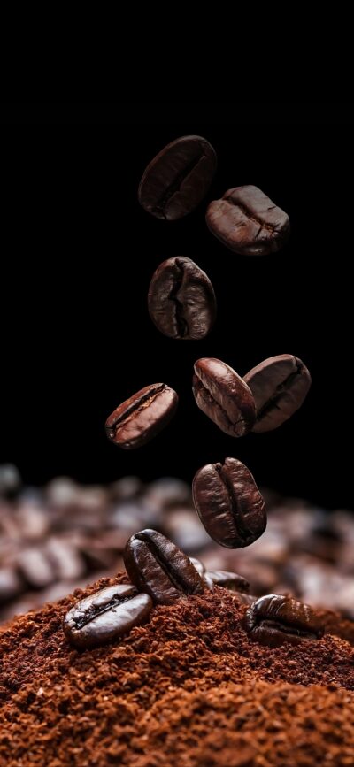 Coffee beans levitate against a dark backdrop, highlighting their rich texture and aroma. | 4K Wallpaper for Mobile