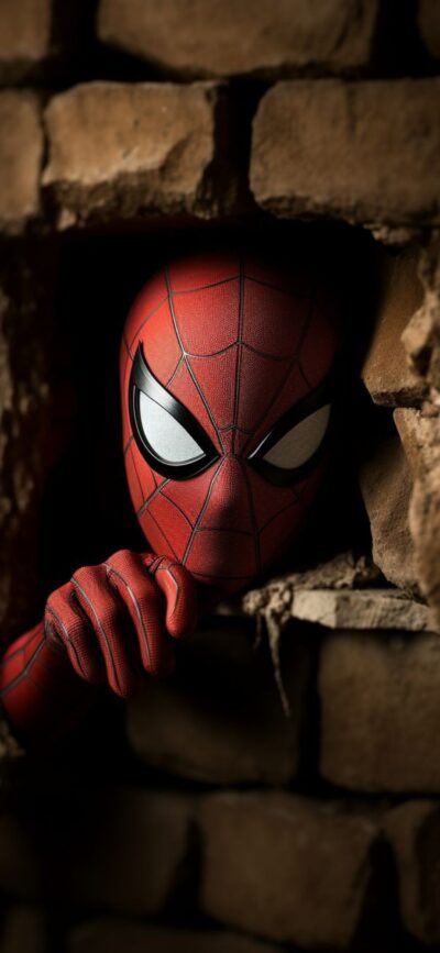 Spiderman peering through a brick wall in red and black costume with white eyes, showcasing stealth and mystery | 4K Wallpaper for Mobile