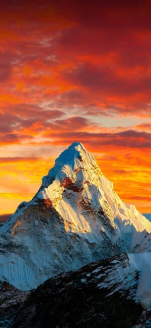 Snow-covered mountain with vibrant sunset sky in orange and red tones, creating a breathtaking landscape | 4K Wallpaper, for Mobile