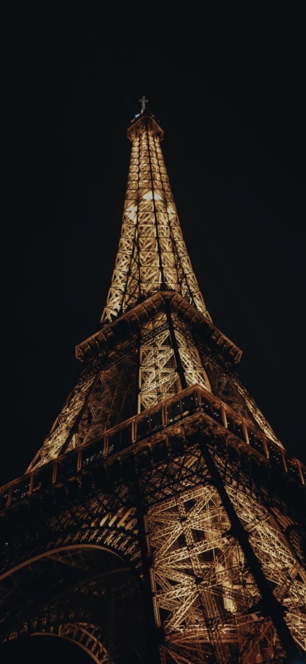 Eiffel Tower at night glowing warm gold against black sky | 4K Wallpaper for Mobile | Black and gold theme | Eiffel Tower, Cityscape, Night.