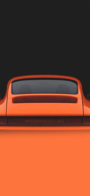 Orange Porsche rear end against black backdrop | 4K Wallpaper for Mobile | Sporty luxury car | Orange & Black wallpaper