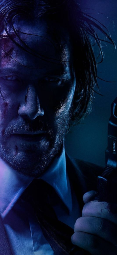 Dramatic close-up of a character with a gun in a shadowy, blue-toned setting. Ideal for action/thriller vibes. | 4K Wallpaper for Mobile