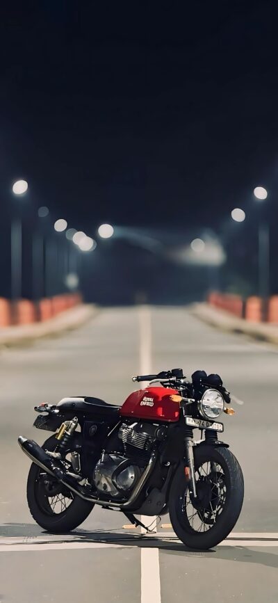 Royal Enfield motorcycle on an empty road under night streetlights in classic design | 4K Wallpaper for Mobile