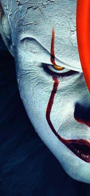 Clown with white makeup, red lines, intense yellow eyes; horror style | White, Red, Yellow, Black | 4K Wallpaper for Mobile