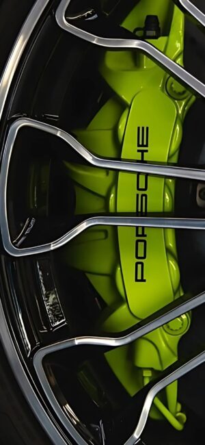 Porsche neon green brake caliper close-up with sleek design, silver wheel spokes. | 4K Wallpaper for Mobile