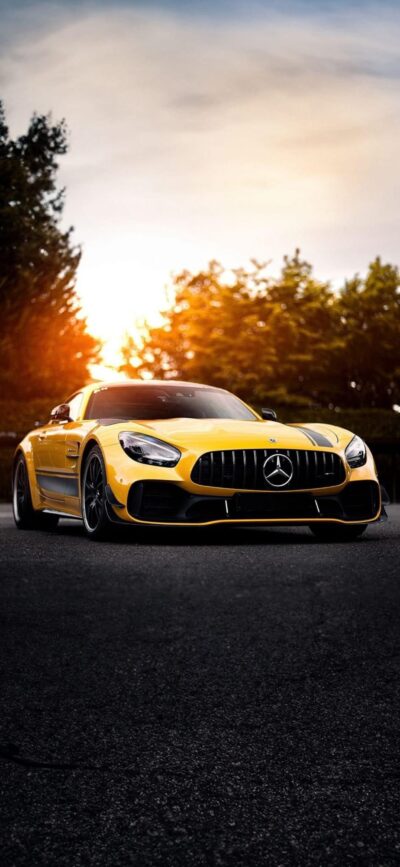 Yellow Mercedes-Benz sports car with sunset & trees backdrop | 4K Wallpaper for Mobile | Luxury & nature blend