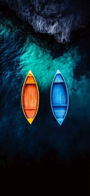 Aerial view of orange and blue boats on vibrant turquoise and dark blue water | 4K Wallpaper for Mobile