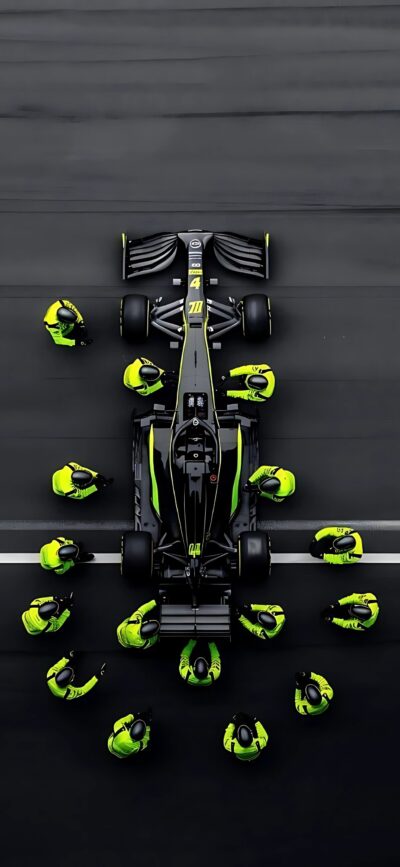 High-angle shot of a Formula 1 car with a pit crew in yellow uniforms on a track | Black, Yellow, Gray | 4K Wallpaper for Mobile