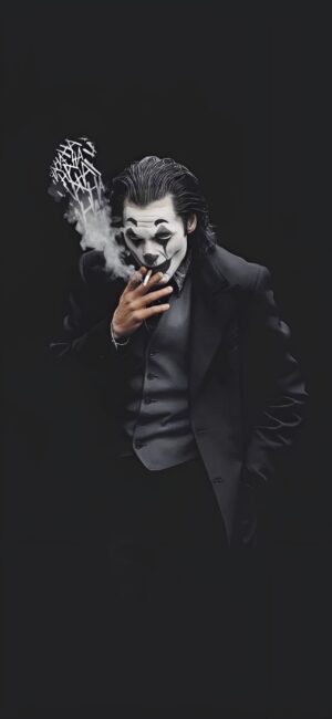 Mysterious figure in a clown-like mask, black suit, exhaling smoke. Intrigue and drama in a dark setting. | 4K Wallpaper for Mobile