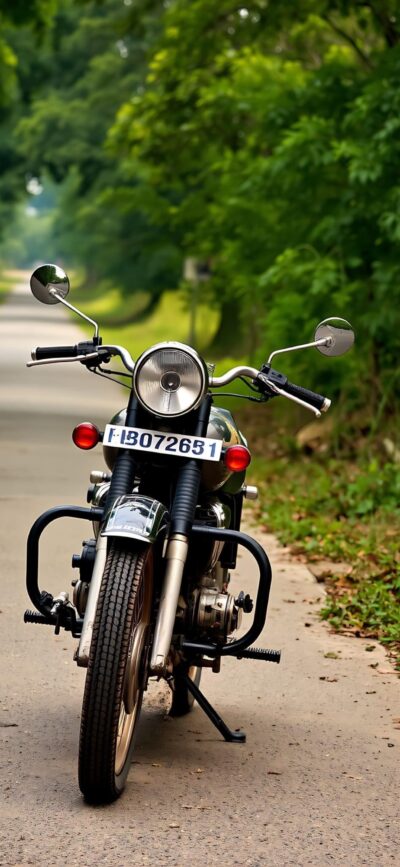 Classic motorcycle amidst lush greenery, showcasing vintage design with chrome handlebars and round headlight | 4K Wallpaper for Mobile