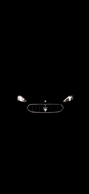 Maserati car front view with grille and headlights on black background, showcasing its luxury emblem & sleek design | 4K Wallpaper for Mobile