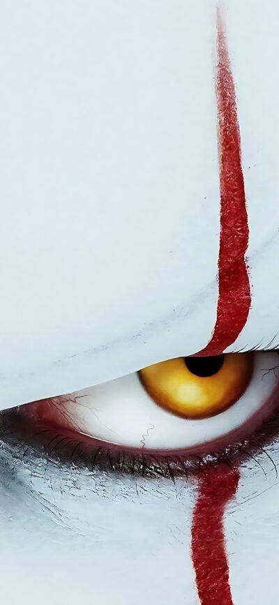 Clown's eerie eye with a red line on a white face, horror theme for mobile | 4K Wallpaper