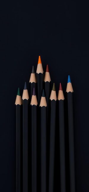 Minimalist colored pencils pattern with black barrels on dark background, featuring various vibrant tips. | 4K Wallpaper for Mobile