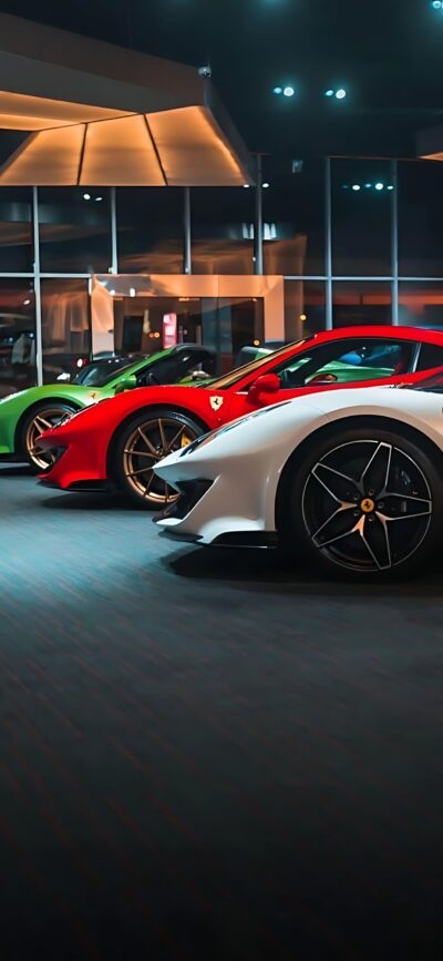 Row of luxury sports cars in a showroom with a white Ferrari in front, red and green cars behind. | 4K Wallpaper for Mobile