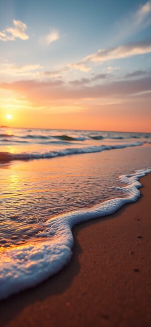 Serene beach with sunset hues, ocean waves, and warm glow | Orange, Blue, Brown | 4K Wallpaper for Mobile