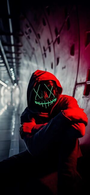 Hooded figure with neon green LED mask in a dim tunnel, cyberpunk vibes. | 4K Wallpaper, for Mobile | Black, Red, Green colors.