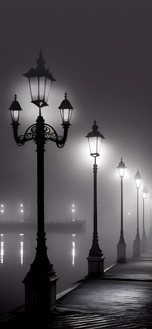 Vintage street lamps on a foggy waterfront, mysterious scene with mist and reflections | Black, White, Grey | 4K Wallpaper for Mobile