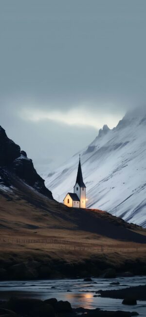 Serene landscape with illuminated church by snow-capped mountains. Peaceful atmosphere. | Blue, White, Gray, Black | 4K Wallpaper for Mobile