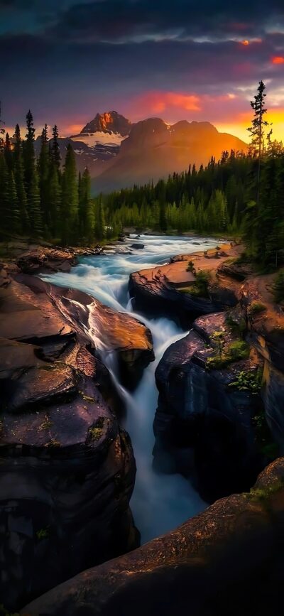 Waterfall cascading through canyon with evergreen forests & mountains under sunset sky | 4K Wallpaper for Mobile