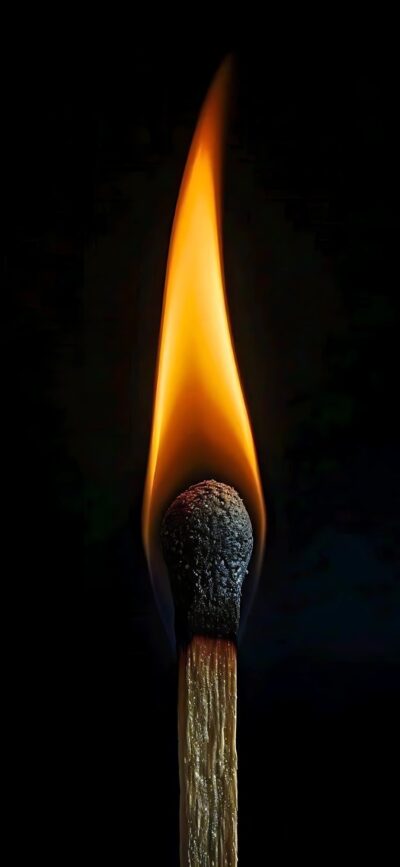 Burning matchstick with bright orange flame on dark background, highlighting simplicity and power of fire | 4K Wallpaper for Mobile