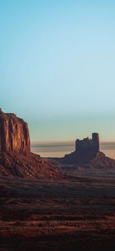 Monument Valley landscape with iconic red rock formations under a blue sky | Brown, Red, Blue | For Mobile | 4K Wallpaper