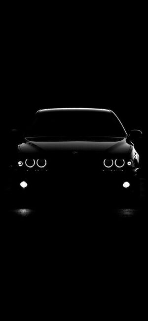 Sleek car front in dark, minimalist style focusing on headlights and contours, elegant silhouette | UHD Wallpaper for Mobile