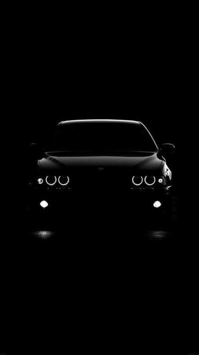 Sleek car front in dark, minimalist style focusing on headlights and contours, elegant silhouette | UHD Wallpaper for Mobile