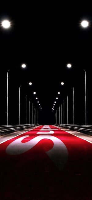 Futuristic bridge at night, lit by streetlights with red and white road pattern. Black, red, white tones | 4K Wallpaper for Mobile