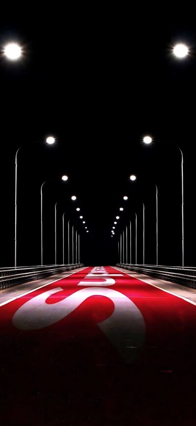 Futuristic bridge at night, lit by streetlights with red and white road pattern. Black, red, white tones | 4K Wallpaper for Mobile