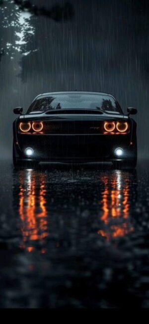 Sleek car with illuminated headlights on rainy night, reflective wet pavement enhances design | 4K Wallpaper for Mobile | Black, Grey, Orange