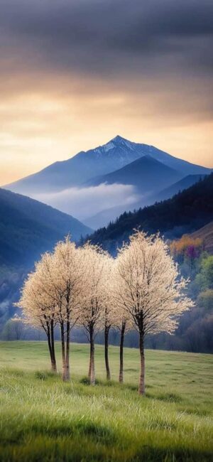 Serene scene with blossoming trees, green hills, snow-capped mountain under cloudy sky | 4K Wallpaper for Mobile