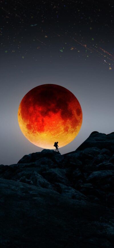 Silhouette on rocky terrain with a vibrant red moon, starry night sky | 4K Wallpaper for Mobile | Black, Red, Orange hues.