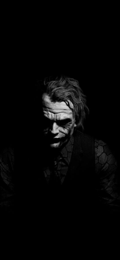 Dark and intense black-and-white Joker-inspired wallpaper with dramatic lighting | 4K Wallpaper for Mobile