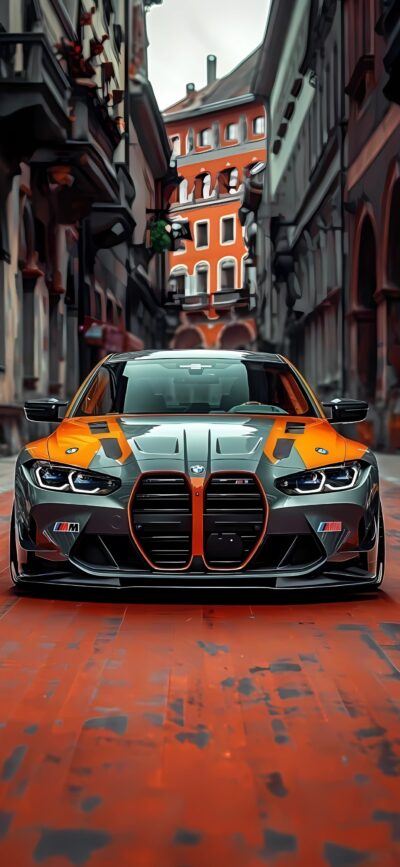 BMW in striking orange and black on a cobblestone street with historic architecture | 4K Wallpaper for Mobile