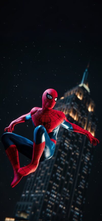 Spiderman swings through a night cityscape with an illuminated skyscraper and dark sky. | 4K Wallpaper, for Mobile