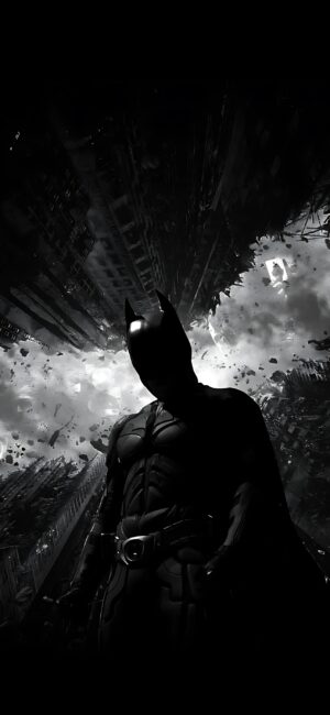 Batman in dramatic cityscape with swirling clouds and debris; silhouette highlighted in gritty urban setting for Mobile | 4K Wallpaper