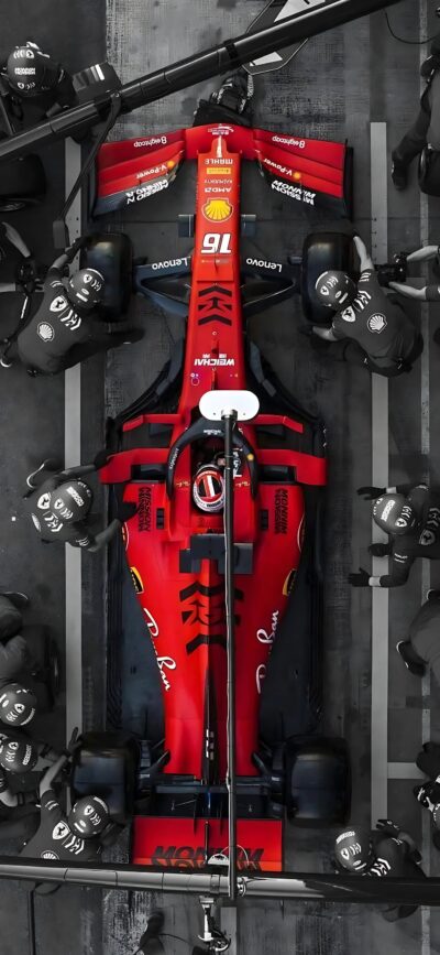 Overhead view of a Ferrari F1 pit stop, showcasing speed, teamwork, vivid red, and racing intensity | 4K Wallpaper for Mobile