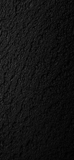 Textured black surface with a rough, granular pattern, creating a dark and sophisticated look | 4K Wallpaper for Mobile