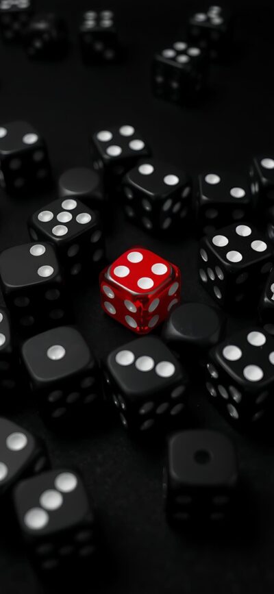 Vibrant red die amidst black dice for a bold, minimalist gaming aesthetic | 4K Wallpaper for Mobile